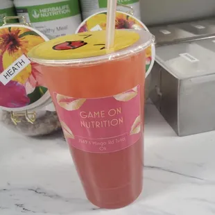 a drink in a plastic cup with a straw