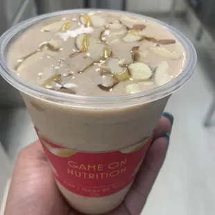 a hand holding a smoothie