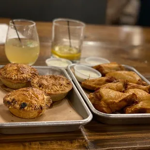 The rest of our Pie Flight (4 Signature Mini Pies) &amp; our traditional wings. Our M.U.L.E on the left &amp; the sour on the right!