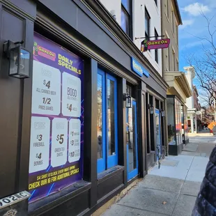 a person walking down a sidewalk in front of a building