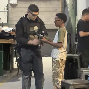 He gifted my son a gun of his that he no longer used. This picture shows him demonstrating how the gun is to be used.