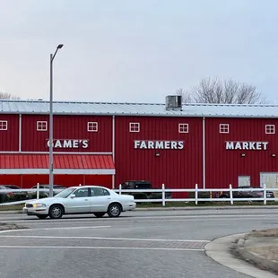 a white car in front of a red building
