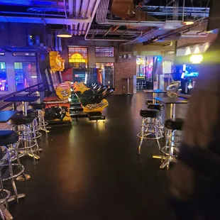 a row of tables and chairs in a game room