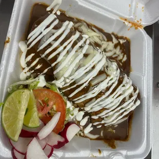 a mexican dish in a styrofoam container