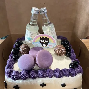 Ube on ube flavored birthday cake with macarons, ferrero rocher, and mini alcohol bottles I requested!
