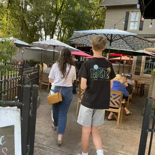 two people walking down the sidewalk