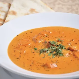 a bowl of soup with bread