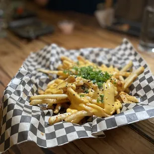 a basket of french fries and a glass of wine
