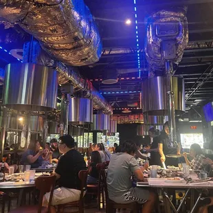 people sitting at tables in a restaurant