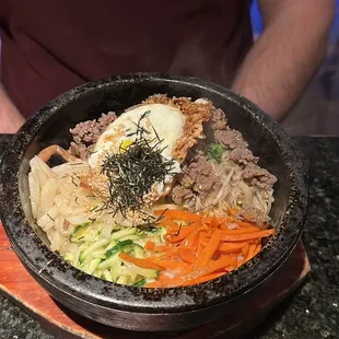 a man holding a bowl of food