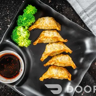 a black plate with broccoli