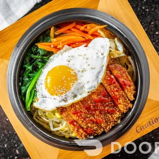 a fried egg on top of noodles