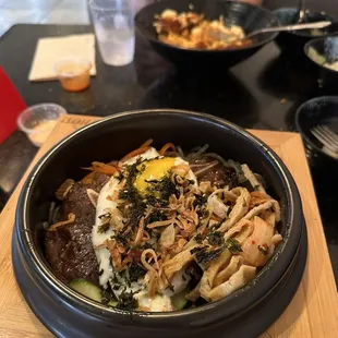 a bowl of noodles with meat and vegetables