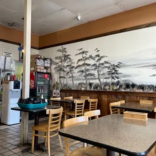 a restaurant with a large mural on the wall