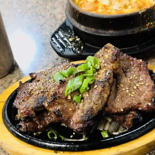 a plate of steak and a bowl of soup