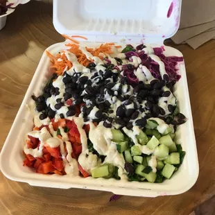 a salad in a styrofoam container