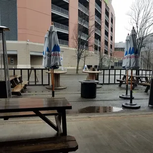 tables and umbrellas on a rainy day