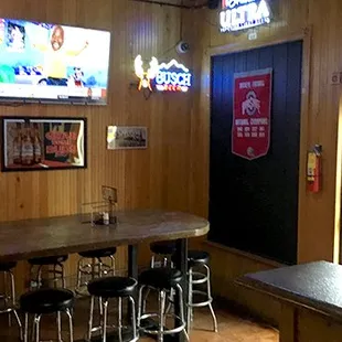 a bar with stools and tables