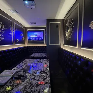 a room with a tv and couches