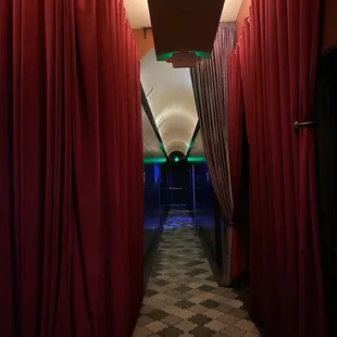 a hallway with red curtains