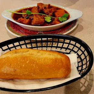 a basket of bread and a bowl of soup on a table