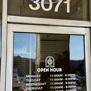 the open sign in the window of a restaurant
