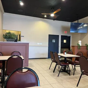 a dining area with tables and chairs