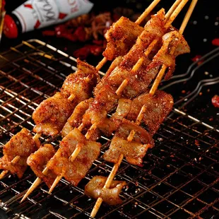 a close up of skewered meat