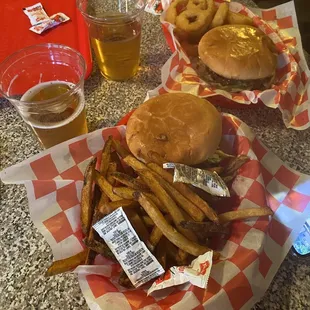 Cheeseburgers with fresh cut fries and onion rings.