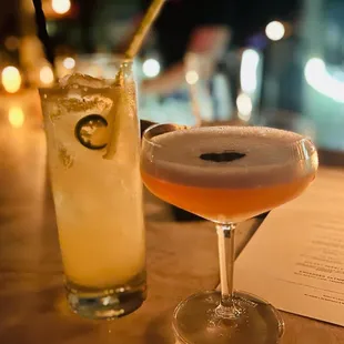two cocktails on a bar table
