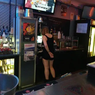 a woman standing at the bar