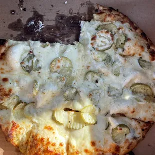 On first plate of dill pickle pizza
