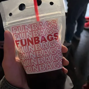 a hand holding a bag of funbags