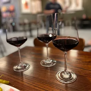 three glasses of wine on a table