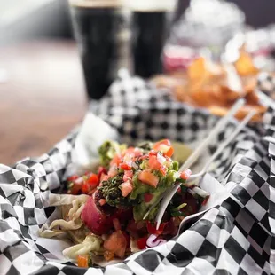 a basket of food and a glass of beer