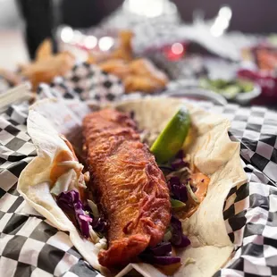 a fish taco on a checkered plate