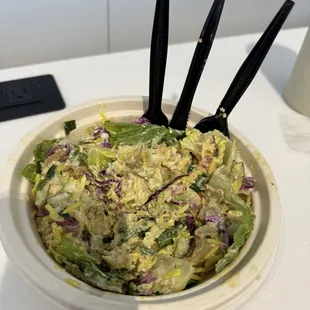 Salad with chicken, tabouli rice and white sauce.