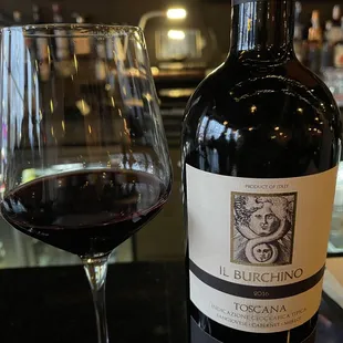 a glass of wine and a bottle of wine