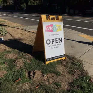 Street sign with hours.