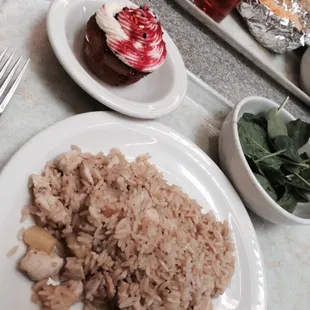 Chicken fried rice with pineapple, baby spinach, strawberry short cake cupcake.