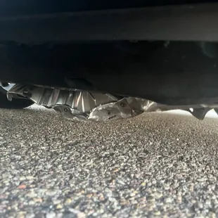 An unscrewed skid plate