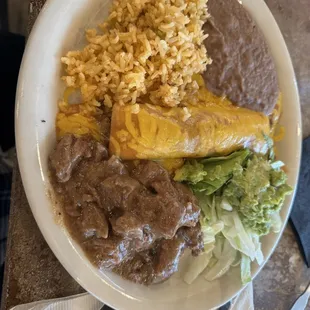 Beef enchilada and carne guisada plate. The carne guisada was the best I've had in a long time!