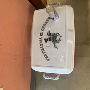 Fresh corn tortillas for sale are kept in a heated cooler.