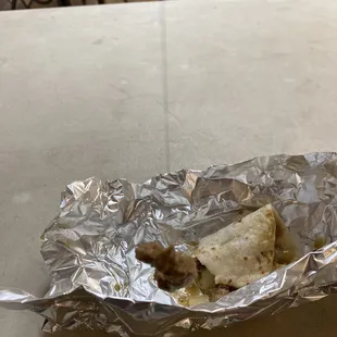 a burrito wrapped in aluminum foil