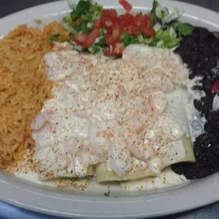 Cancun enchiladas (stuffed with guacamole, shrimp on top and white wine sauce)
