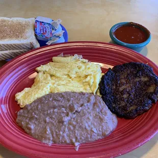 Sausage, eggs, refried beans, toast, and red chili