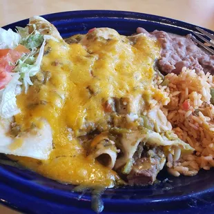 Carnitas enchilada with rice and beans