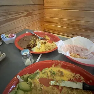 Enchiladas and chicken breast with cheese.