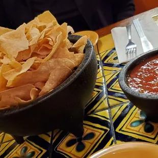 a bowl of tortilla and a bowl of salsa