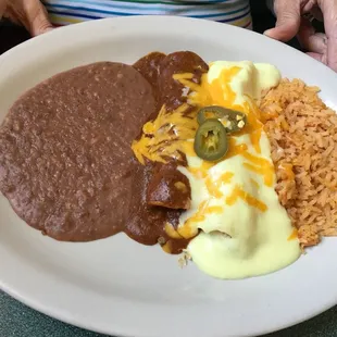From the Lunch Menu: Beef and chicken enchiladas with rice and refried beans.  Chips and salsa come with the meals.